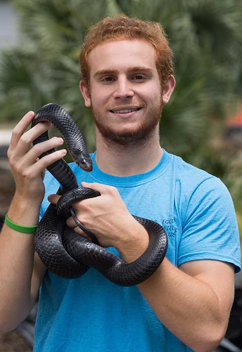 Photo shows student with snake