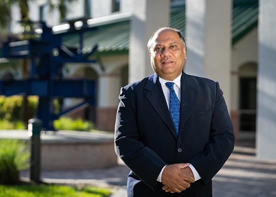 Man in blue suit standing outdoors